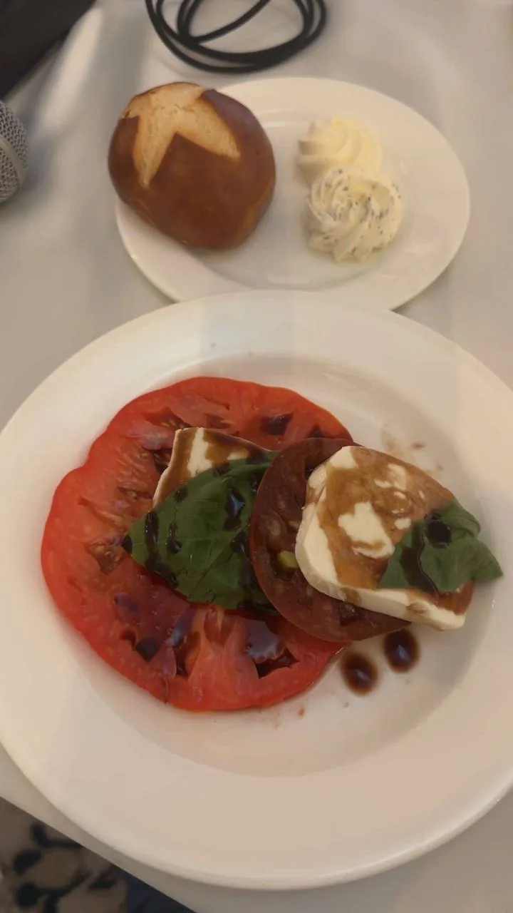 Heirloom tomato and mozzarella caprese appetizer with pretzel roll at the Hotel Carmichael wedding reception