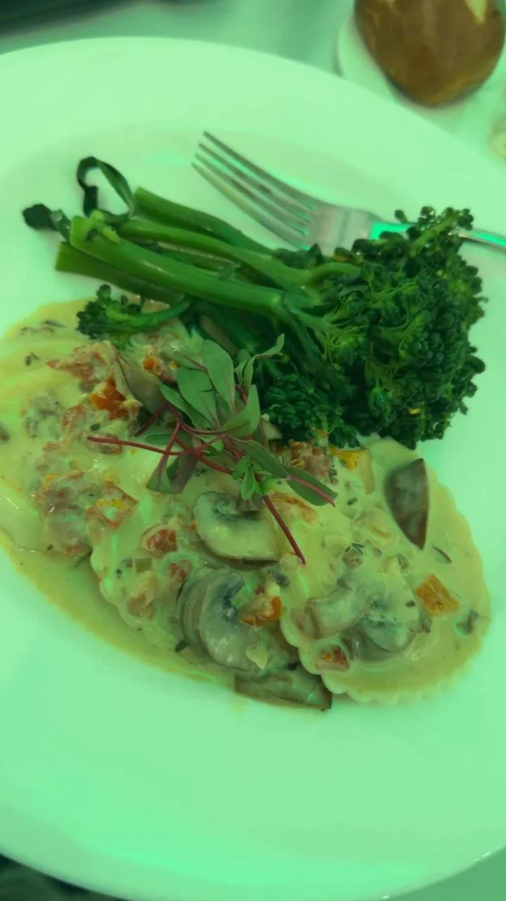 Plated mushroom ravioli entree with broccolini served at the Hotel Carmichael wedding reception